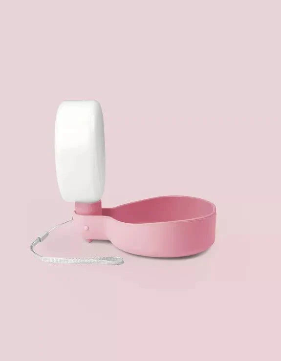 Dusty pink dog water bottle with anti-drip valve, compact design.