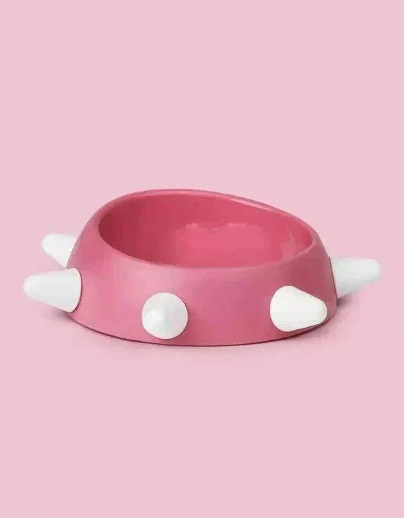 Eco-friendly sloping dog bowl with pink and white studs, non-slip, dishwasher safe, 500ml capacity.