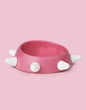 Eco-friendly sloping dog bowl with pink and white studs, non-slip, dishwasher safe, 500ml capacity.