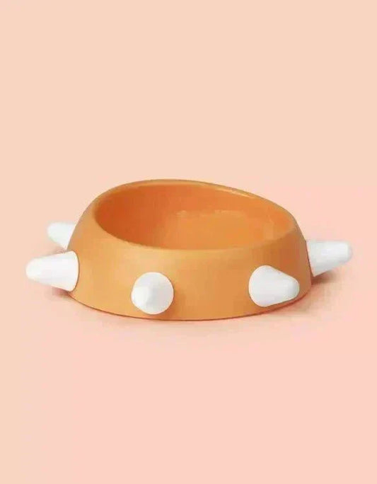 Eco-friendly sloping dog bowl with orange color and white studs.