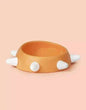 Eco-friendly sloping dog bowl with orange color and white studs.