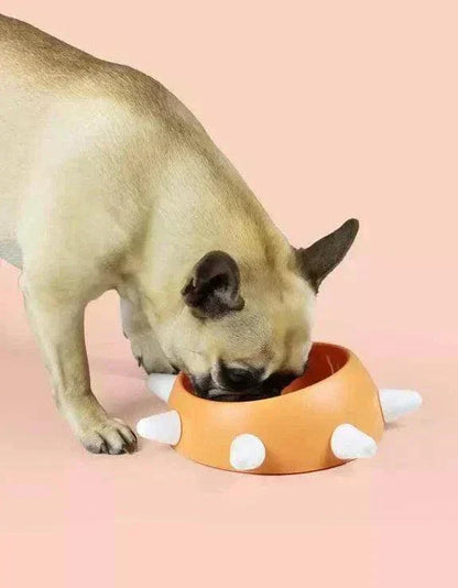 Orange sloping dog bowl with white studs, ideal for brachycephalic dogs, non-slip and eco-friendly.